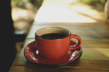 Cup of coffee on wooden table, space for text