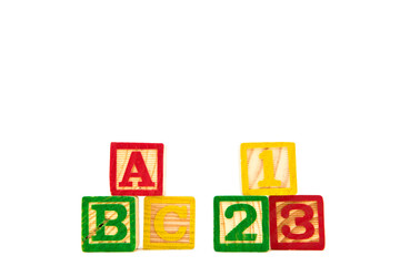 Colored letter cubes made from wood spelling ABC and 123 to illustrate the concept of learning. Isolated on white.