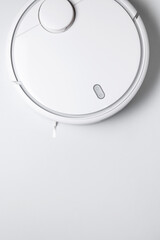 Modern robot vacuum cleaner on gray background flat lay. New technologies, quick house cleaning, automatic robot assistant. Free time to relax. Future technology, smart appliance for cleaning house