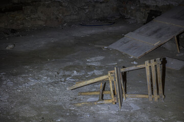 broken lying wooden chair in a castle