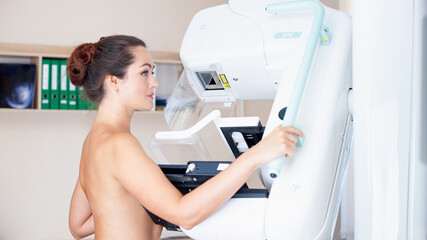Fototapeta na wymiar Healthy young woman doing cancer prophylactic mammography scan at hospital.