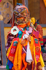 Bumthang in Bhutan at the yearly  festival in the monastery of Jakar. A monk is wearing  a colourful traditional mask.