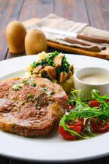 Fried pork meat, mashed potato, mushrooms and tomato