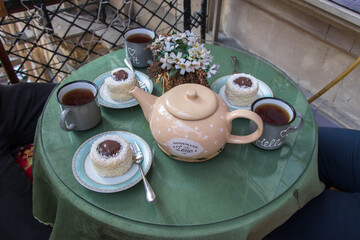 Teapot and teacup in vintage style. Tea time on the balcony