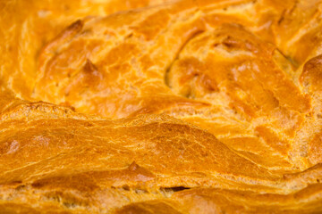 background, texture of the surface of a baked cake with a crispy crispy crust