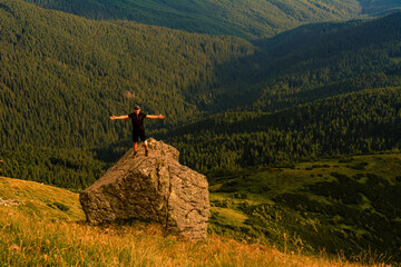 The top of Mount Pip Ivan, a tourist admires the scenery from the top, a hike in the Ukrainian...