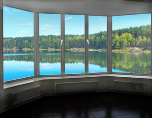 Fototapeta premium Room with big window in room with panoramic view to forest lake