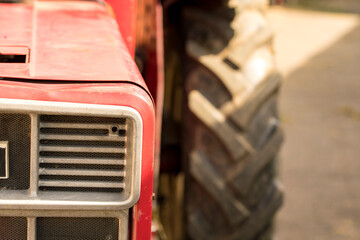Fototapeta na wymiar Old red seed tractor from the front