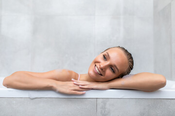 Portrait of a young woman relaxing in the bathtube