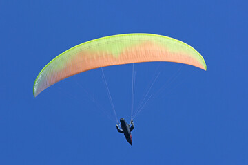 Paraglider flying wing in a blue sky	