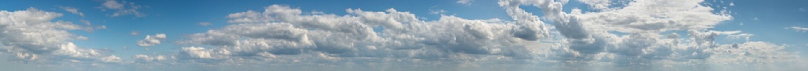 Fantastic clouds against blue sky, panorama
