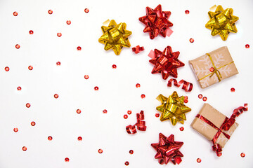 Gift boxes and bows on a white background.Confetti and candy are scattered.