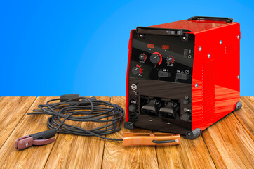 Welding machine with stick electrode holder, work cable and clamp on the wooden table. 3D rendering - obrazy, fototapety, plakaty