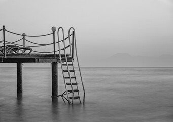 spectacular sunset on a peer in Mediterranean Sea with long exposure and a blurred background. Turkey, Belek, august 2020