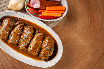 .Roll steak in delicious tomato sauce. Top view. Copy space