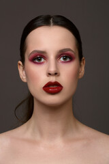 Fashionable portrait of a girl with bright makeup. red lipstick and red eyeshadow