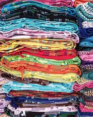multiple coloured dupattas stacked on top for sale