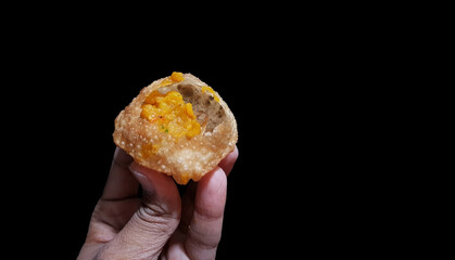 puchka paanipuri golgappa isolated on black background © Arindam