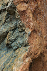 Green Serpentine rock, a thin layer on the outside colored reddish due to forming of iron oxide