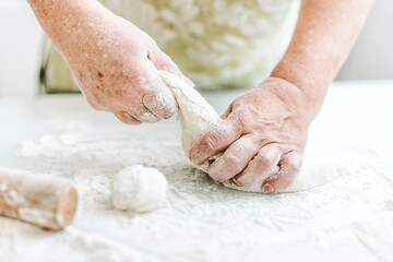 Woman kneading dough at home kitchen