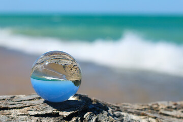 Obraz premium Crystal ball for optical illusion. Nature view through a crystal ball.