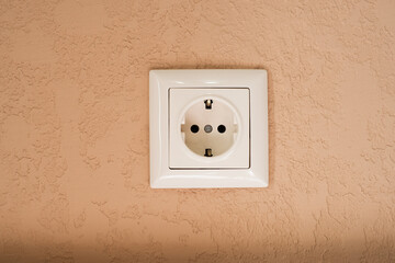 white socket on brown wall