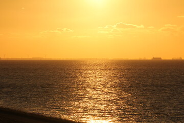 Fototapeta premium an orange sky during sunset in summer above a black sea