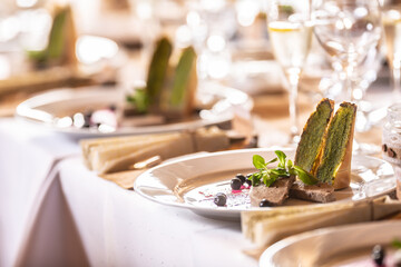 Festive tableware with a foie gras appetizer prepared for the dinner