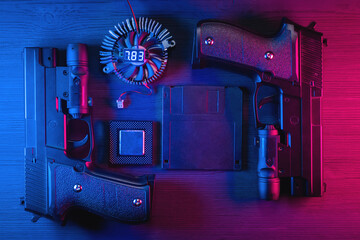 Floppy disk data, cpu chip, guns on black table flat lay background in the neon lights.