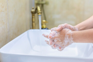 Woman washing and disinfecting hands with soap and hot water. Prevention for covid 19