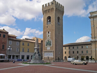 Fototapeta na wymiar Italy, Marche, Recanati, the civic tower, the Leopardi statue in Leopardi square.