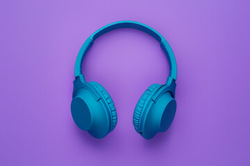 Stylish blue headphone on purple background. Music concept.