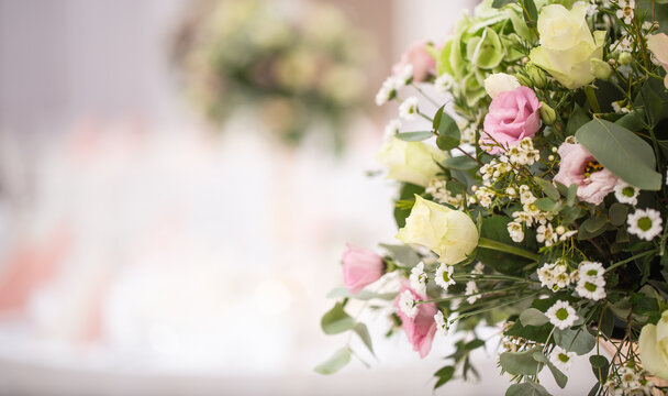 Detail of a wedding flower bouquet with pink roses situated in the right side of the picture