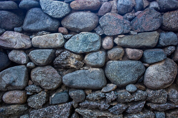 Stone wall texture, big and small rocks forming a wall
