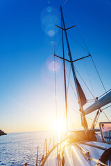 Yacht Sailing against sunset. Sailboat. Travel Concept