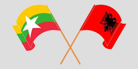 Crossed and waving flags of Myanmar and Albania