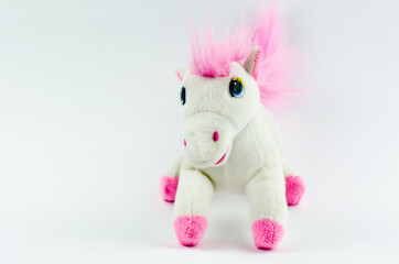 White horse with a pink mane on a white background. Kids toy