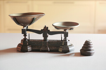Old obsolete manual weighing scales and a pile of weights