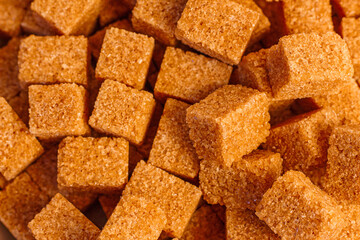 food background image: brown cane sugar cubes in a sugar bowl