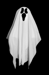White ghost from the blanket on black background. Halloween decoration. 