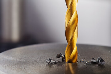 metal drill bit make holes in steel billet on industrial drilling machine. Metal work industry....