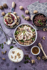 top view of gourmet dish with Figs fruits, nuts, honey, couscous and pomegranate seeds on table