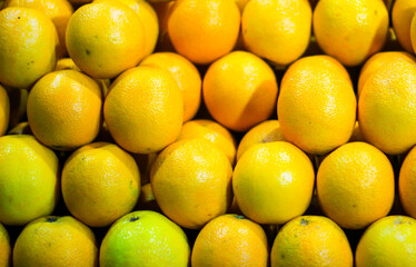 heap of ripe yellow sweet lime for sale in market