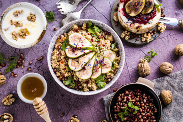 top view of gourmet dish with Figs fruits, nuts, honey, couscous and pomegranate seeds on table