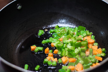 finely chopped vegetables fried in oil in a frying pan closeup view