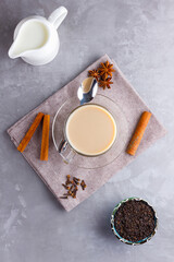 Masala chai tea. Traditional indian drink - masala tea with spices on gray background. Top view