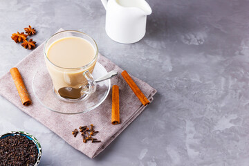 Masala chai tea. Traditional indian drink - masala tea with spices on gray background. Copy space. Top view