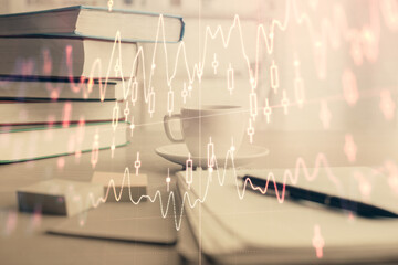 Double exposure of financial chart drawing and desktop with coffee and items on table background. Concept of forex market trading