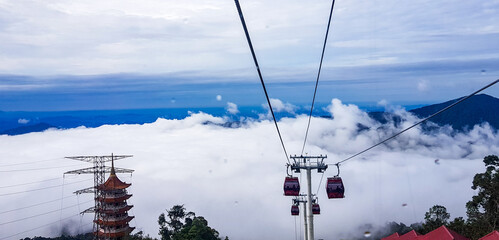 cable car at genting highlands, malaysia in a foggy weather with green grass visible from inside...