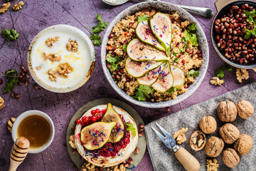 top view of gourmet dish with Figs fruits, nuts, honey, couscous and pomegranate seeds on table